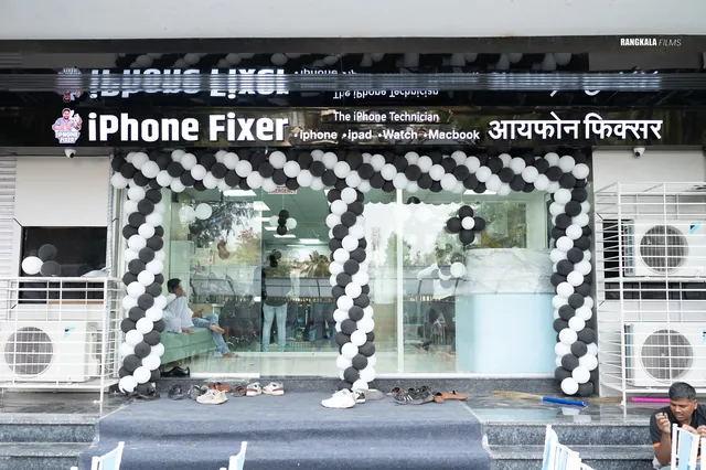 iPhone Fixer shopfront in Nashik, its entrance framed with black and white balloons